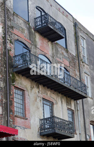 Savannah, Georgia, USA - January 20, 2017:  Historical wrought iron balconies and architecture along River Street, a popular tourist destination in Sa Stock Photo