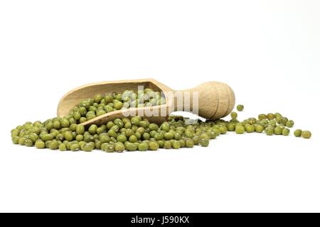 wooden scoop with mung beans isolated on white background