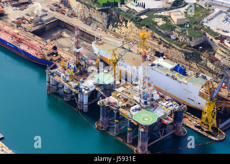 Dry dock and oil platform repair in Valletta Grand Harbour, Malta. Stock Photo