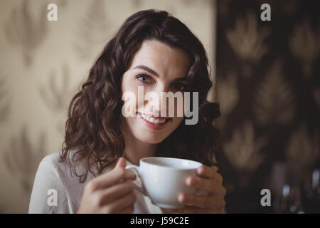 Portrait of young woman having coffee in restaurant Stock Photo