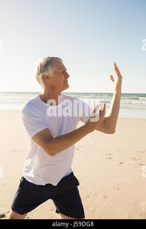 Active senior man practicing yoga Stock Photo