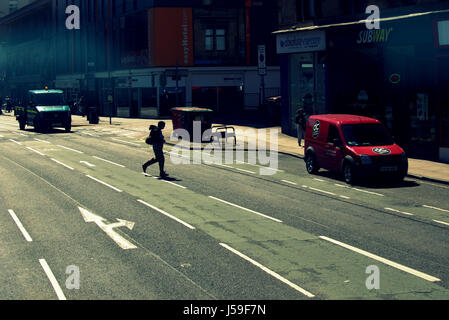 man silhouette crossing street back lit jay walking Stock Photo