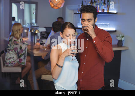 Couple drinking cocktails together in bar restaurant Stock Photo