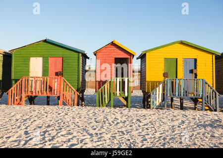 Multi colored huts on sand against clear sky at beach Stock Photo