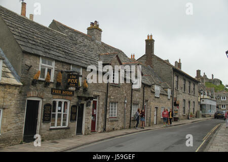 Swanage, UK -  12 May: The Fox Inn on West Street in the Corfe Castle village. The building is constructed using the locally available Purbeck stone. General view of the seaside town of  Swanage in Dorset, England.  © David Mbiyu/Alamy Live News Stock Photo