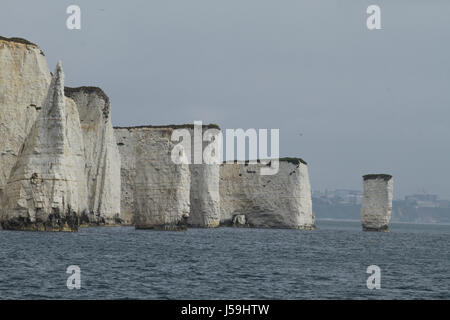 Swanage, UK -  12 May: View of the Old Harry Rocks from a boat plying the Poole Swanage route. The rocks are three chalk formations, including a stack and a stump, located at Handfast Point, on the Isle of Purbeck in Dorset. General view of the seaside town of  Swanage in Dorset, England.  © David Mbiyu/Alamy Live News Stock Photo