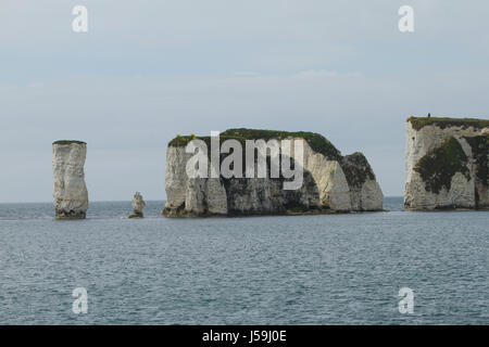 Swanage, UK -  12 May: View of the Old Harry Rocks from a boat plying the Poole Swanage route. The rocks are three chalk formations, including a stack and a stump, located at Handfast Point, on the Isle of Purbeck in Dorset. General view of the seaside town of Swanage in Dorset, England.  © David Mbiyu/Alamy Live News Stock Photo