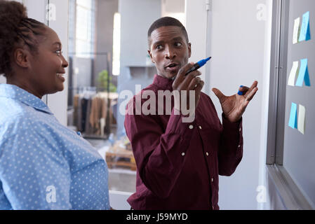 Modern African colleagues planning with sticky notes in an office Stock Photo