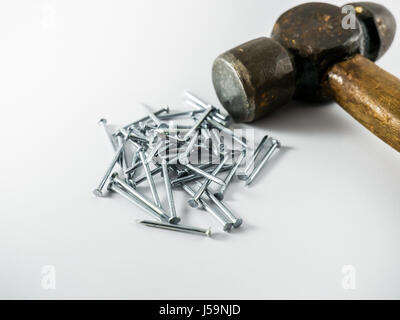 A number of nails and a hammer Stock Photo