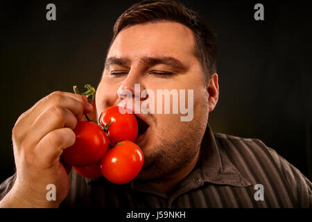 Diet fat man eating healthy food . Healthy breakfast with vegetables. Stock Photo