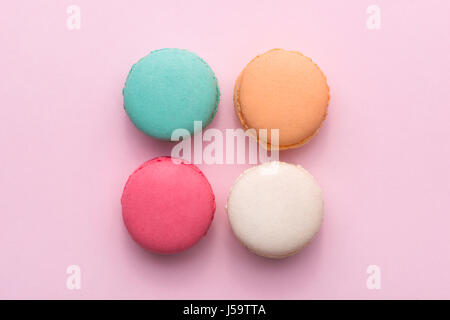 Colorful pastel cake macaron or macaroon on pink background from above Stock Photo