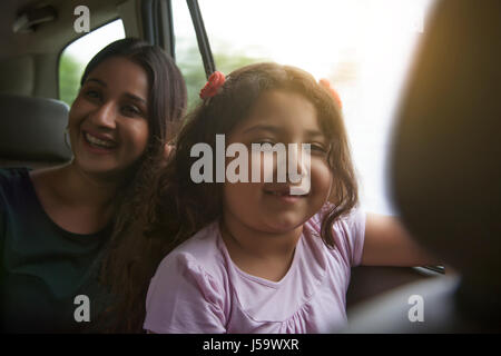 Happy mother and daughter traveling in a car Stock Photo