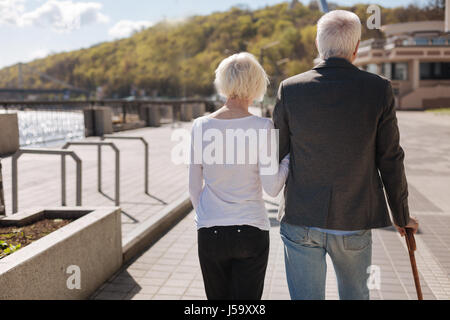 Nice aged couple having rest in the park Stock Photo