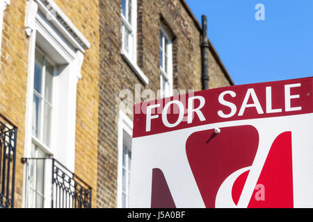 London, UK - April 8, 2017 - For Sale sign outside a English townhouse Stock Photo