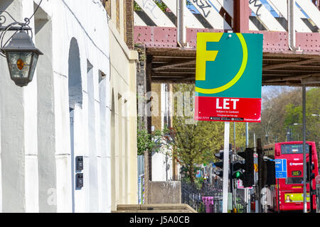 London, UK - April 8, 2017 - To Let sign outside a English townhouse with a London street in the background Stock Photo