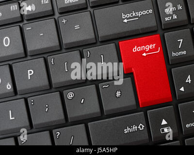 Closeup of keyboard with enter key and danger sign. Stock Photo