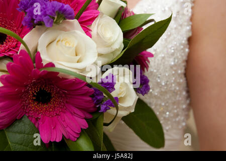 Brides wedding dress detail with flowers Stock Photo