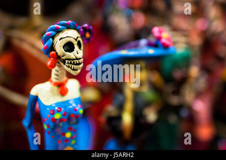 Calaca figurines are sold on the market during the Day of the Dead holiday in Mexico City, Mexico. Stock Photo