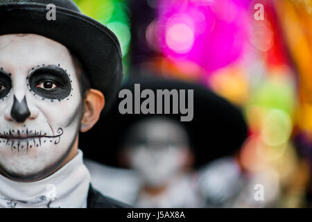 A young man, dressed as La Catrina, walks through the town during the Day of the Dead parade in Mexico City, Mexico. Stock Photo