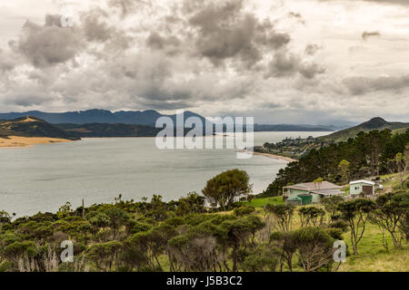 Bay of Islands, New Zealand - March 7, 2017: Opononi town on shore of Hokianga Harbour seen from Ti Pikinga Reserve. Wide shot of mountains, the Hokia Stock Photo