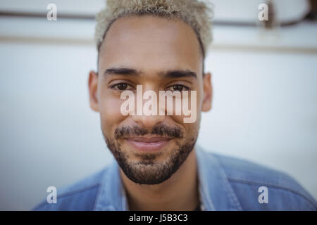 Portrait of smiling young man against van Stock Photo
