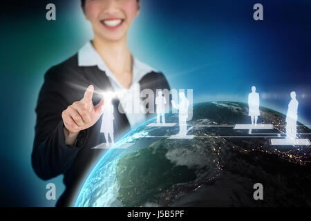 Happy businesswoman touching digital screen against blue background with vignette Stock Photo