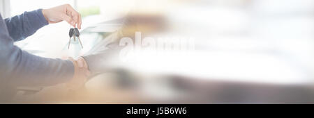 People shaking each other hands while holding keys Stock Photo