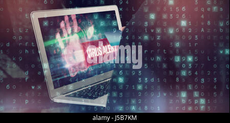 Mid section of hacker using credit card and laptop  against virus alert against blue technology design with binary code Stock Photo