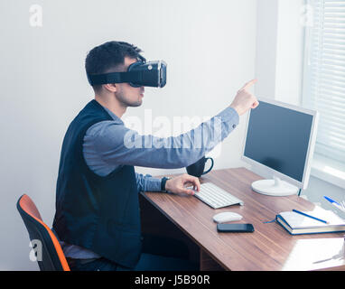 Young businessman in vr glasses drawing chart with gesture Stock Photo