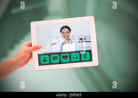 Masculine hand holding tablet against empty bed in the hospital room Stock Photo