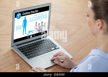 kinesiology team online against businesswoman using laptop Stock Photo