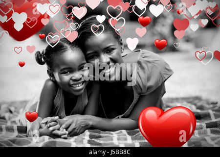 Love heart pattern against portrait of happy family posing together Stock Photo