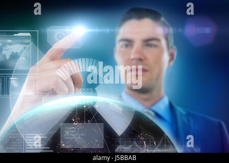 Businessman touching digital screen against blue background with vignette Stock Photo
