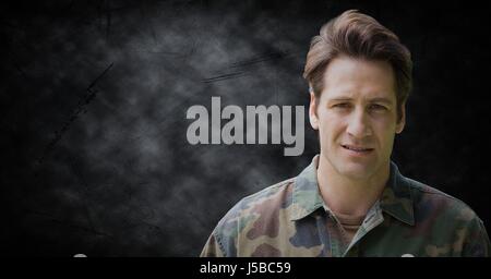 Digital composite of Soldier against black grunge background Stock Photo