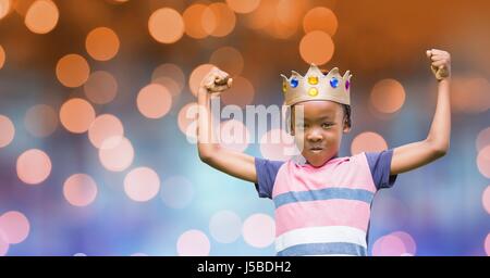 Digital composite of Portrait of kid wearing crown while flexing muscles Stock Photo