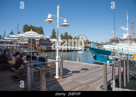Fremantle,WA,Australia-November 13,2016: Kaili's Fish Market Cafe with tourists, boats, Norfolk Pines and ferris wheel in Fremantle, Western Australia Stock Photo