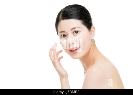 Attractive pretty Chinese Asian women put lotion cream on skin and become moist flexible isolated on white background. fashion beauty and health conce Stock Photo