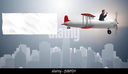 Biplane with businessman and blank banner Stock Photo