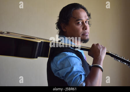 Young man with guitar, Pune, Maharashtra Stock Photo