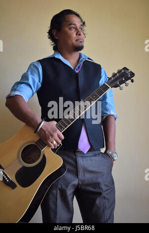 Young man with guitar, Pune, Maharashtra Stock Photo