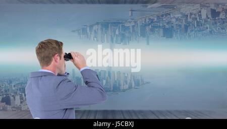 Digital composite of Businessman using binoculars to see upside down city Stock Photo