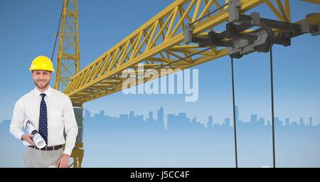Digital composite of Architect holding blueprint against crane Stock Photo