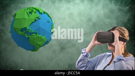 Digital composite of Businesswoman wearing VR glasses by low poly earth Stock Photo