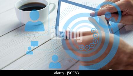 Digital composite of Hands using tablet PC with overlays Stock Photo