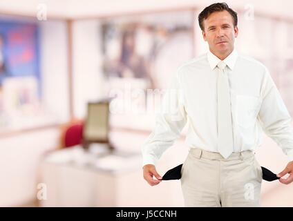 Digital composite of Mature businessman showing empty pockets Stock Photo