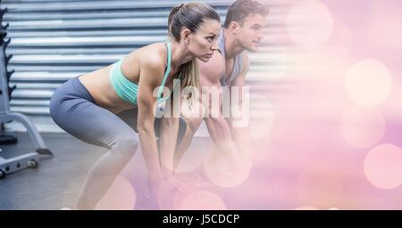 Digital composite of Woman and man exercising in gym Stock Photo