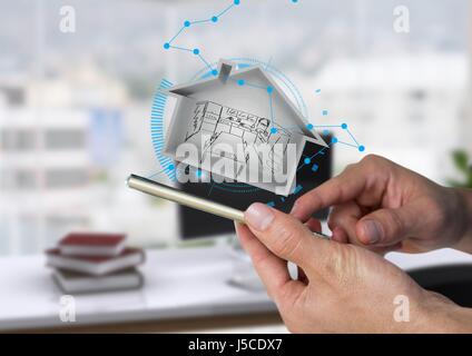 Digital composite of house with draw inside  on phone. in the office Stock Photo