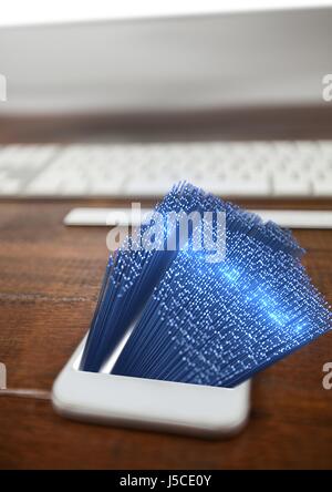 Digital composite of house going out of phone on the desk Stock Photo