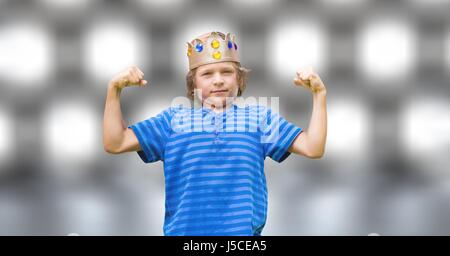 Digital composite of Portrait of confident boy in king crown flexing muscles over bokeh Stock Photo
