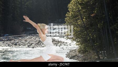 Digital composite of Double exposure of woman performing yoga in forest Stock Photo